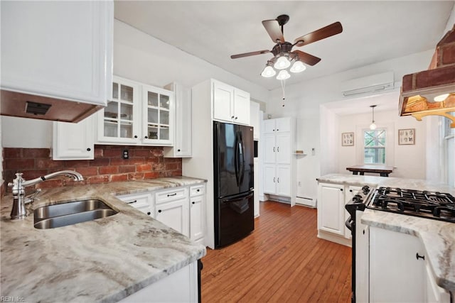 3716 Colonial Ave, Norfolk, VA 23508 - kitchen featuring freestanding refrigerator, a sink, a wall mounted AC, ceiling fan, and gas range