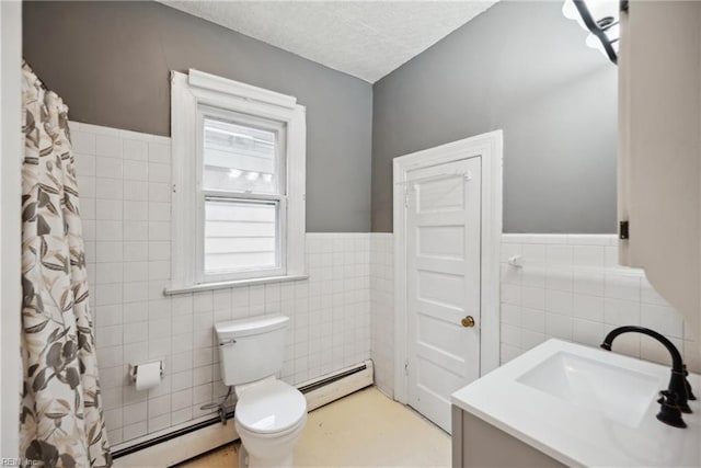 3716 Colonial Ave, Norfolk, VA 23508 - bathroom featuring baseboard heating, tile walls, toilet, vanity, and wainscoting