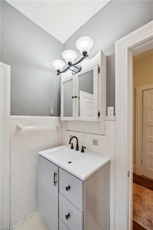 3716 Colonial Ave, Norfolk, VA 23508 - bathroom featuring a chandelier, tile walls, vanity, and a wainscoted wall
