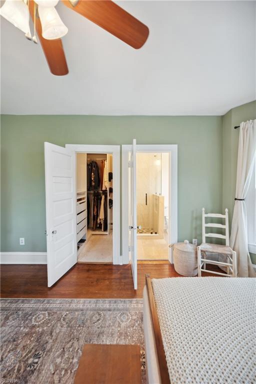3716 Colonial Ave, Norfolk, VA 23508 - bedroom with wood finished floors, a closet, a walk in closet, connected bathroom, and baseboards