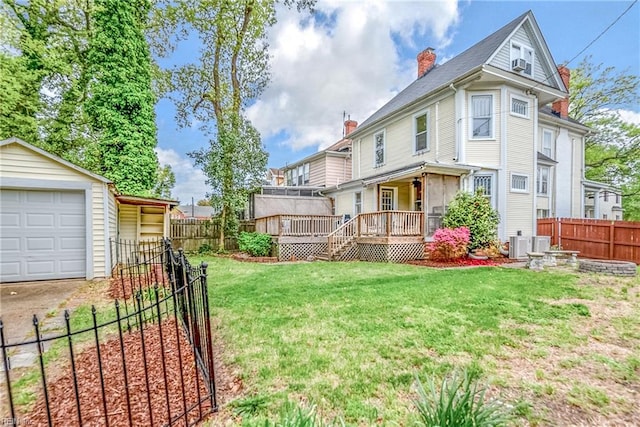 3716 Colonial Ave, Norfolk, VA 23508 - back of house with a chimney, a wooden deck, an outbuilding, driveway, and a garage