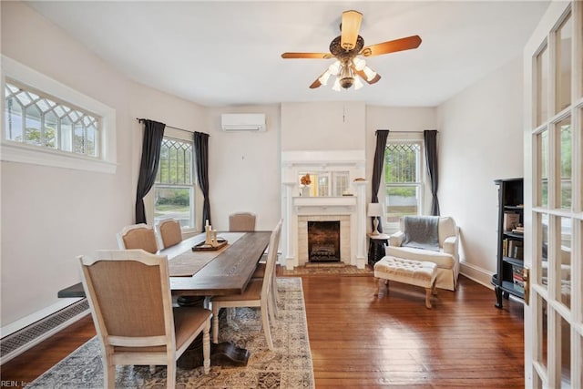 3716 Colonial Ave, Norfolk, VA 23508 - dining area featuring a wall unit AC, a fireplace, wood finished floors, and ceiling fan