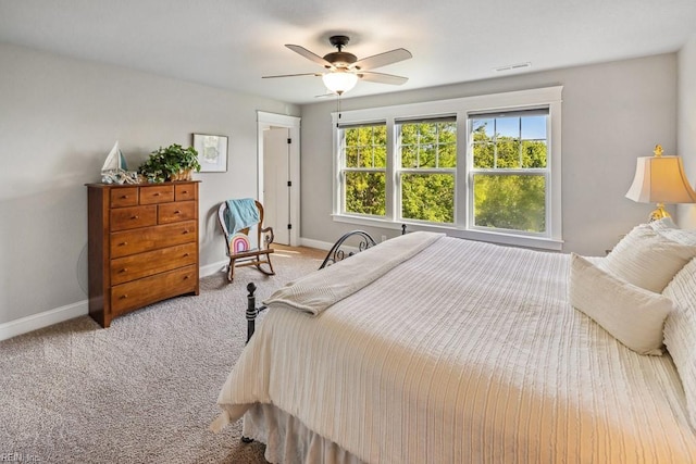 bedroom featuring ceiling fan, baseboards, visible vents, and carpet