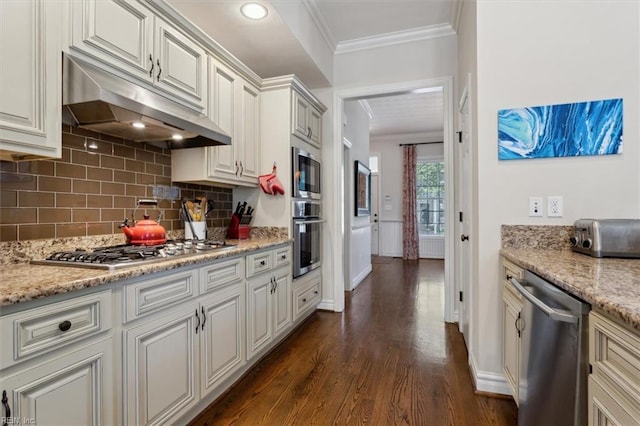 kitchen featuring crown molding, appliances with stainless steel finishes, backsplash, under cabinet range hood, and dark wood-style floors