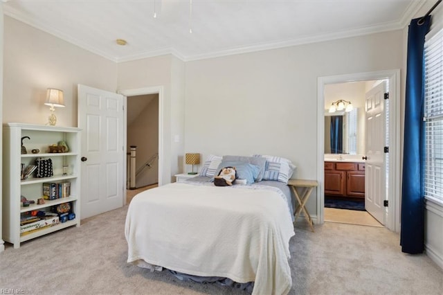 bedroom featuring ensuite bathroom, light colored carpet, and crown molding
