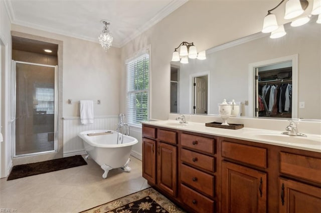 full bath with a freestanding bath, double vanity, a shower stall, and a sink