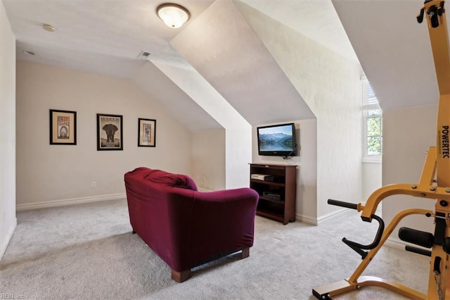 living area featuring baseboards, vaulted ceiling, visible vents, and light colored carpet