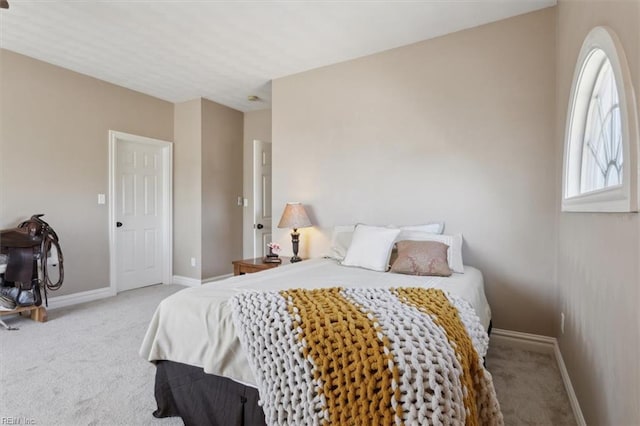 carpeted bedroom featuring baseboards