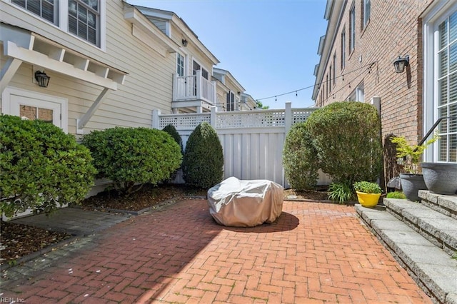 view of patio featuring fence and area for grilling