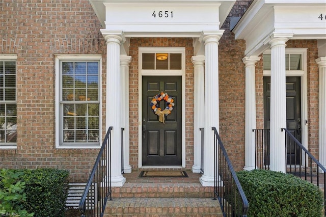 view of exterior entry with brick siding