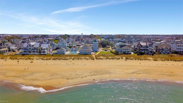 birds eye view of property featuring a beach view, a water view, and a residential view
