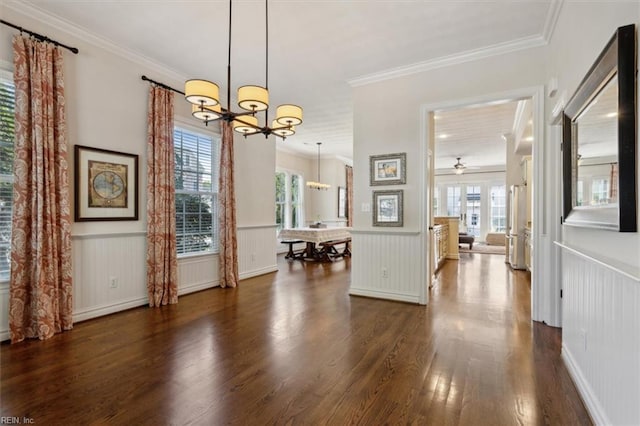 dining room featuring ceiling fan with notable chandelier, crown molding, dark wood-style floors, and wainscoting