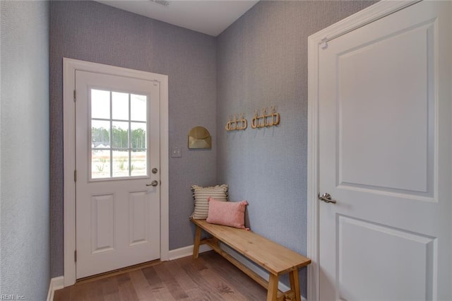 mudroom with wood finished floors and baseboards