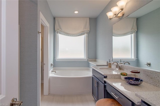 bathroom with a bath and vanity