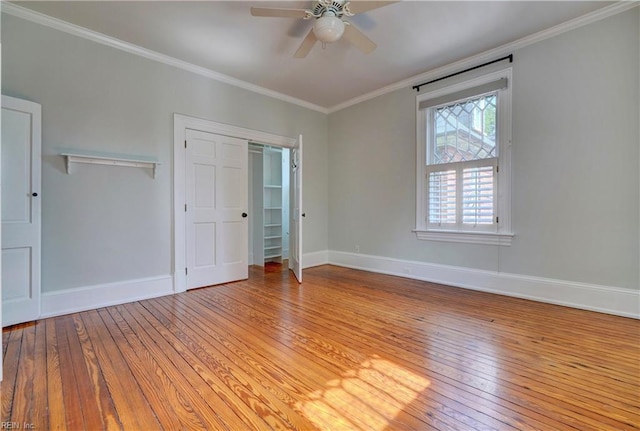 unfurnished bedroom with ceiling fan, baseboards, light wood-style floors, and ornamental molding