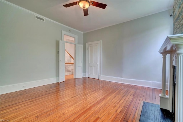 unfurnished living room featuring visible vents, crown molding, hardwood / wood-style flooring, and ceiling fan