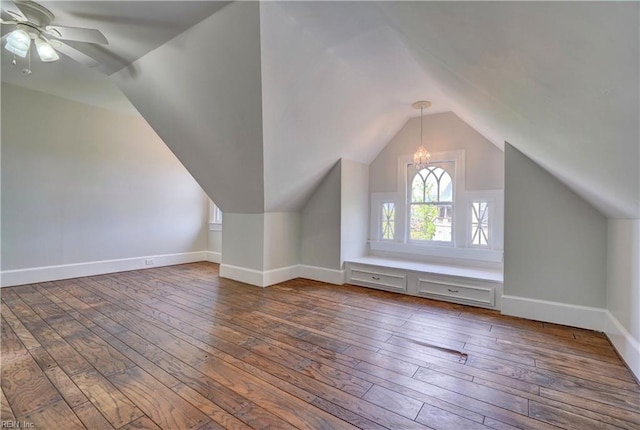 bonus room with baseboards, vaulted ceiling, hardwood / wood-style flooring, and ceiling fan