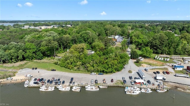 birds eye view of property featuring a wooded view and a water view