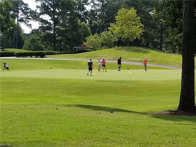 view of home's community featuring a yard and golf course view