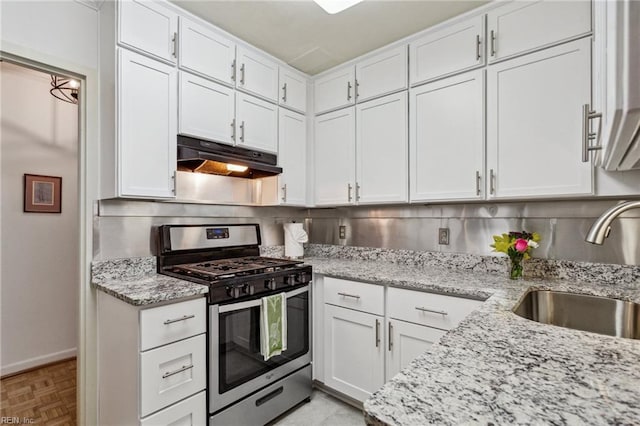 7320 Glenroie Ave Unit 2F, Norfolk, VA 23505 - kitchen featuring light stone countertops, baseboards, gas range, white cabinetry, and under cabinet range hood