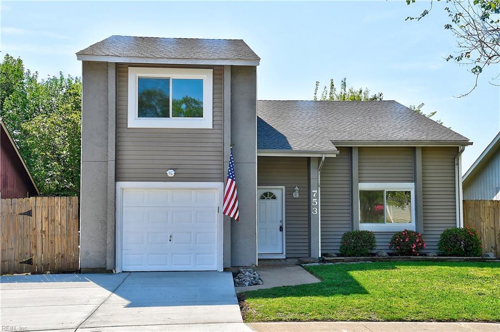 753 Deer Lake Dr, Virginia Beach, VA 23462 - view of front of home with a front lawn, concrete driveway, fence, a garage, and a shingled roof