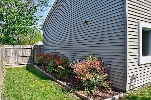 view of side of home with fence
