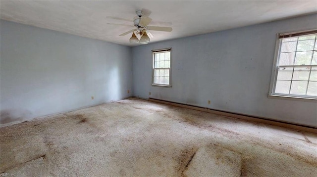 carpeted empty room featuring ceiling fan