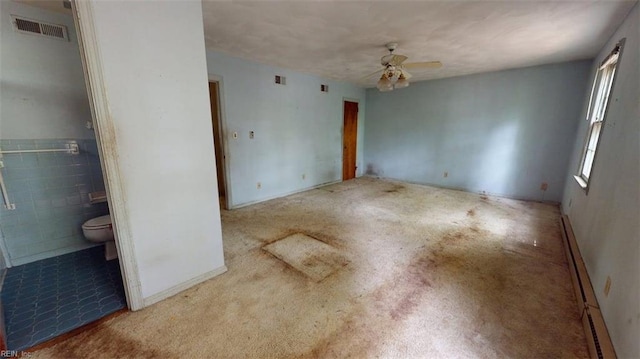 empty room with carpet floors, ceiling fan, and visible vents