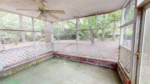 unfurnished sunroom with ceiling fan