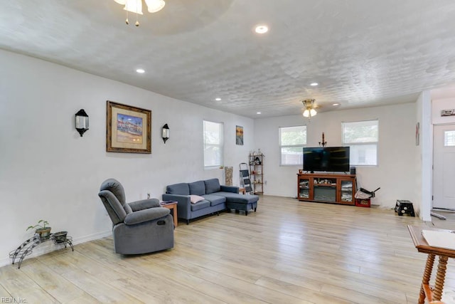 living area with recessed lighting and light wood-type flooring