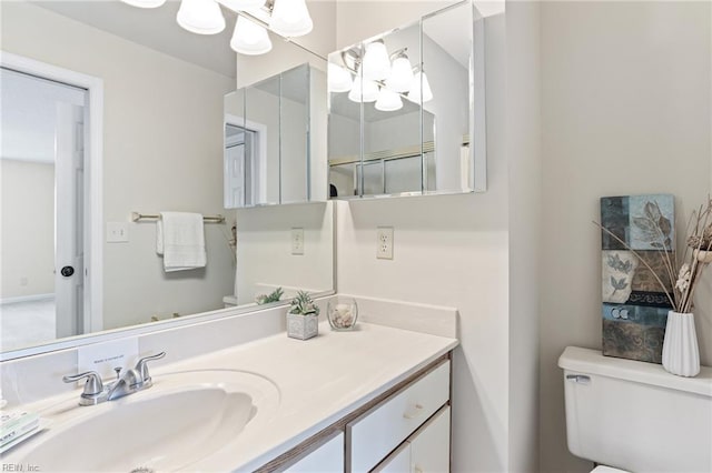 bathroom featuring toilet and vanity