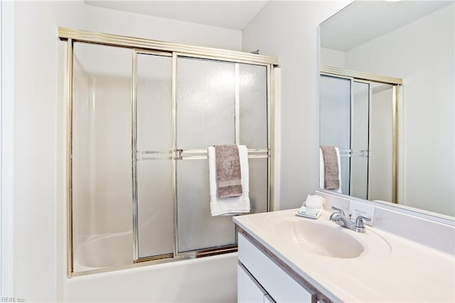 bathroom featuring vanity and shower / bath combination with glass door