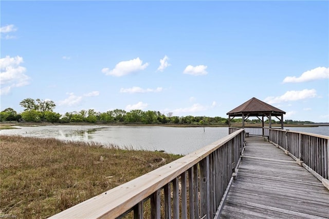 view of dock with a gazebo and a water view
