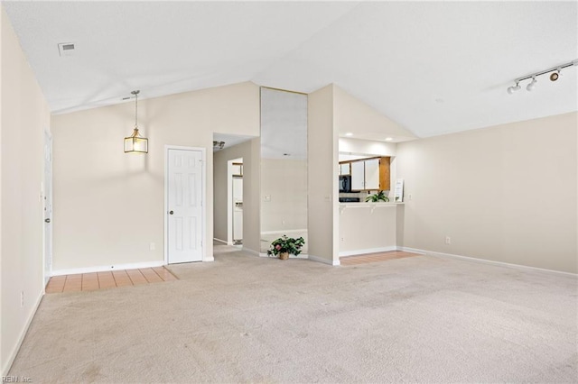 unfurnished living room with visible vents, vaulted ceiling, baseboards, and carpet floors
