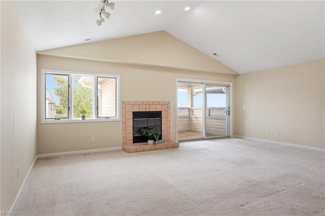 unfurnished living room featuring vaulted ceiling, baseboards, carpet, and a fireplace