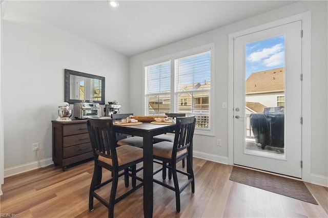 dining area featuring recessed lighting, baseboards, and light wood-type flooring