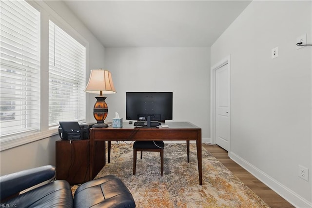 home office with wood finished floors and baseboards