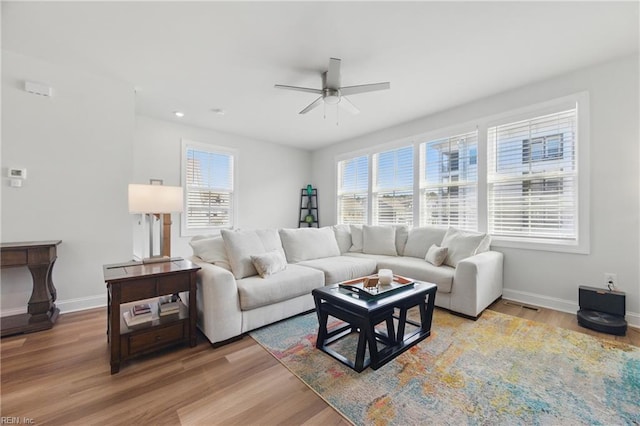living room with light wood-style floors, a ceiling fan, recessed lighting, and baseboards