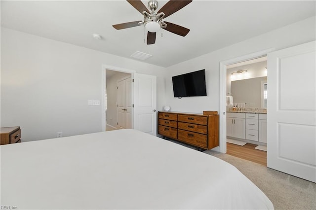 bedroom with ceiling fan and ensuite bath