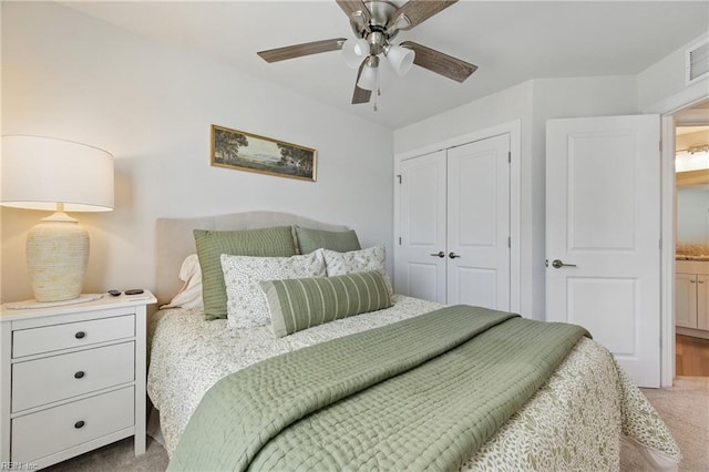 bedroom featuring visible vents, ceiling fan, a closet, and carpet floors