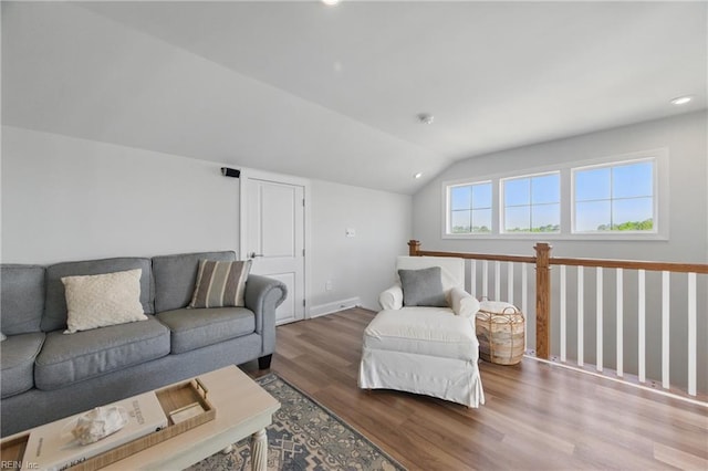 living area with recessed lighting, wood finished floors, lofted ceiling, and baseboards