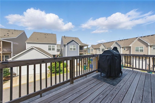 wooden deck featuring area for grilling and a residential view