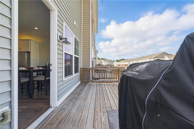 wooden terrace featuring a grill