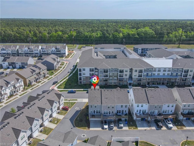 drone / aerial view featuring a view of trees and a residential view