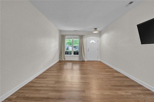interior space featuring wood finished floors, visible vents, and baseboards