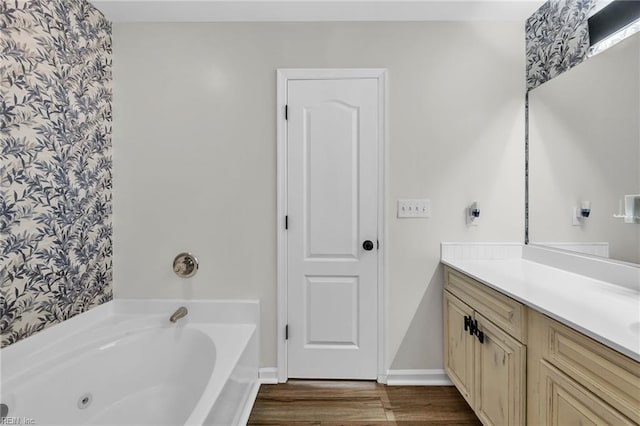 full bathroom with a bath, vanity, and wood finished floors