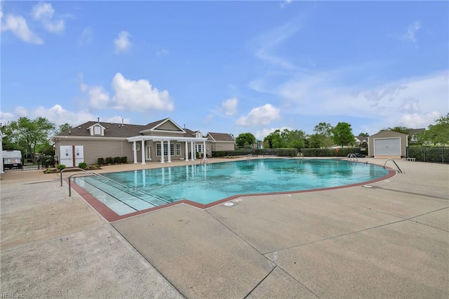 community pool featuring fence and a patio area