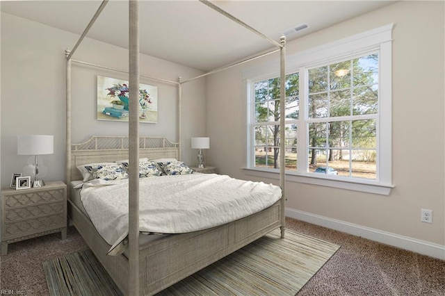 carpeted bedroom featuring visible vents and baseboards
