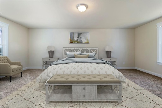 carpeted bedroom featuring baseboards