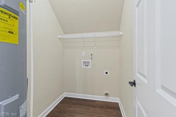 laundry area featuring dark wood-style floors, hookup for a washing machine, water heater, baseboards, and laundry area